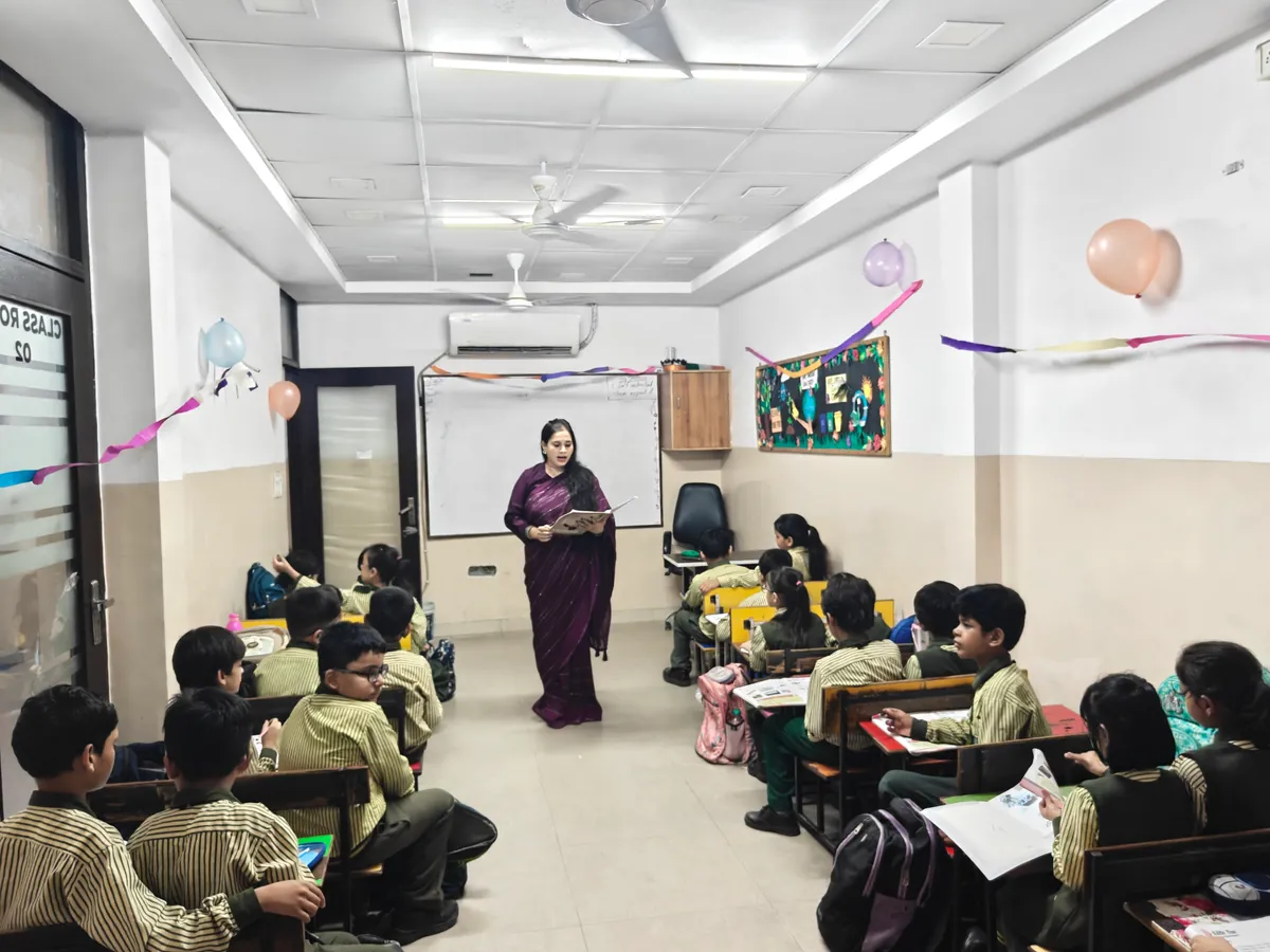 Teacher guiding Garden Public School students